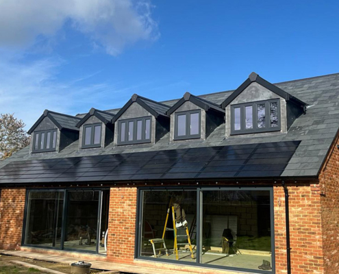 0008_Solar Tiles Under Dormers On New Roof Which Also Has Brazilian Slate In South England